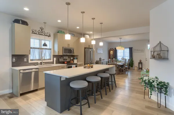 a large kitchen with a table and chairs