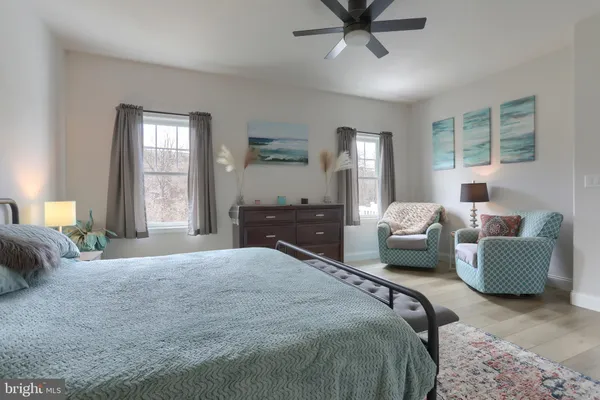 a spacious bedroom with a bed and a couch