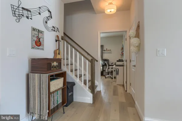 a view of entryway and hall with wooden floor