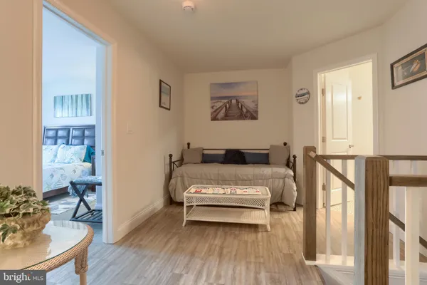 a spacious bedroom with a bed and a table in it