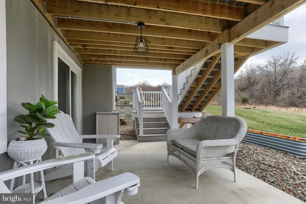 a balcony with furniture and a potted plant
