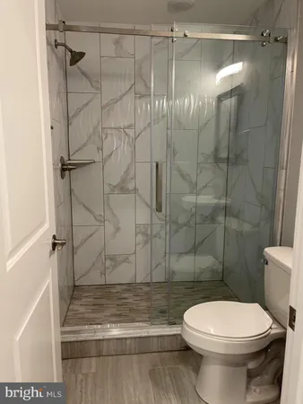 a bathroom with a toilet and a shower