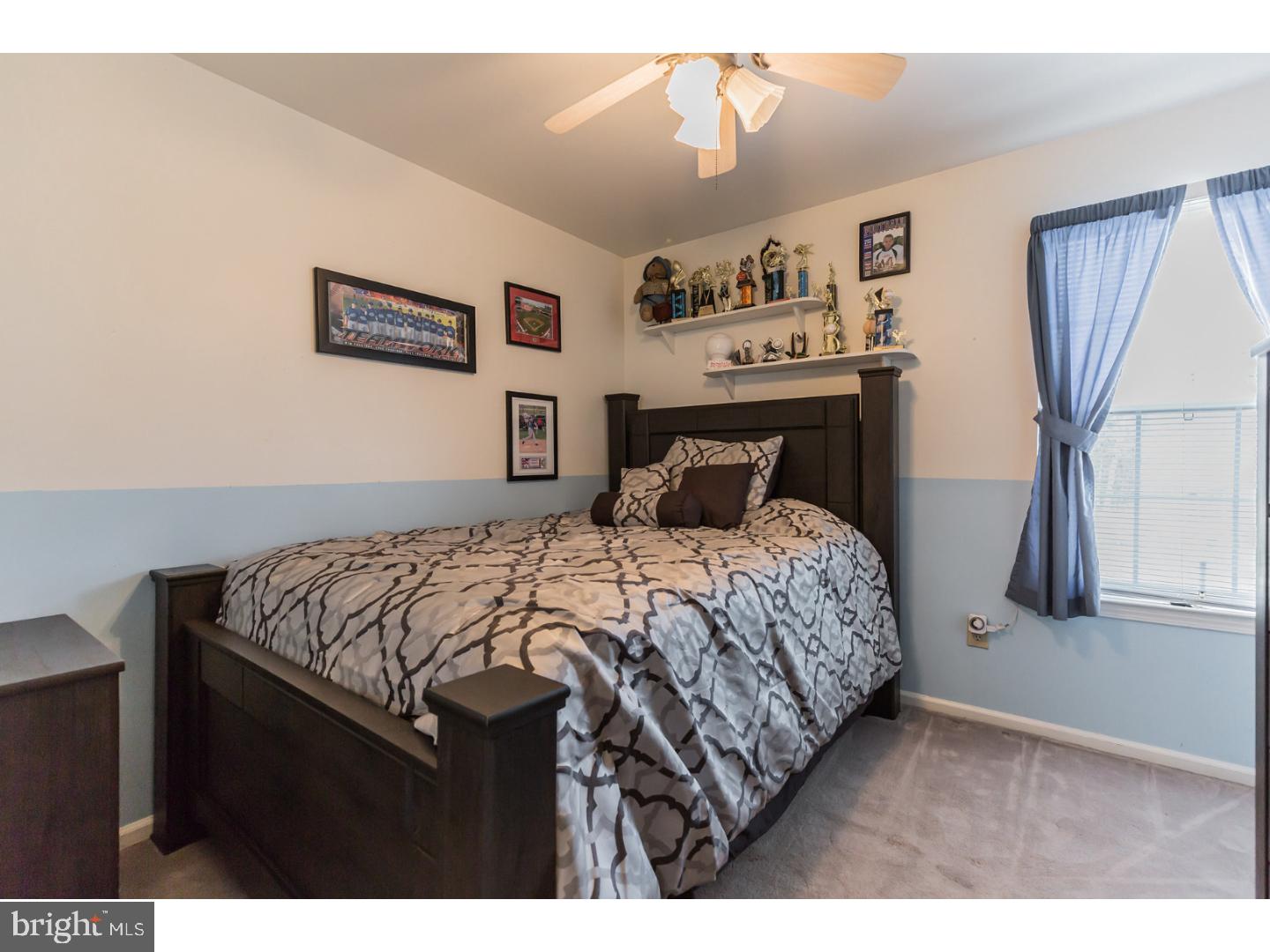 69 Country Club Road Pine Hill, NJ 08021 - Photo 14 of 25 a bedroom with a bed and a chandelier