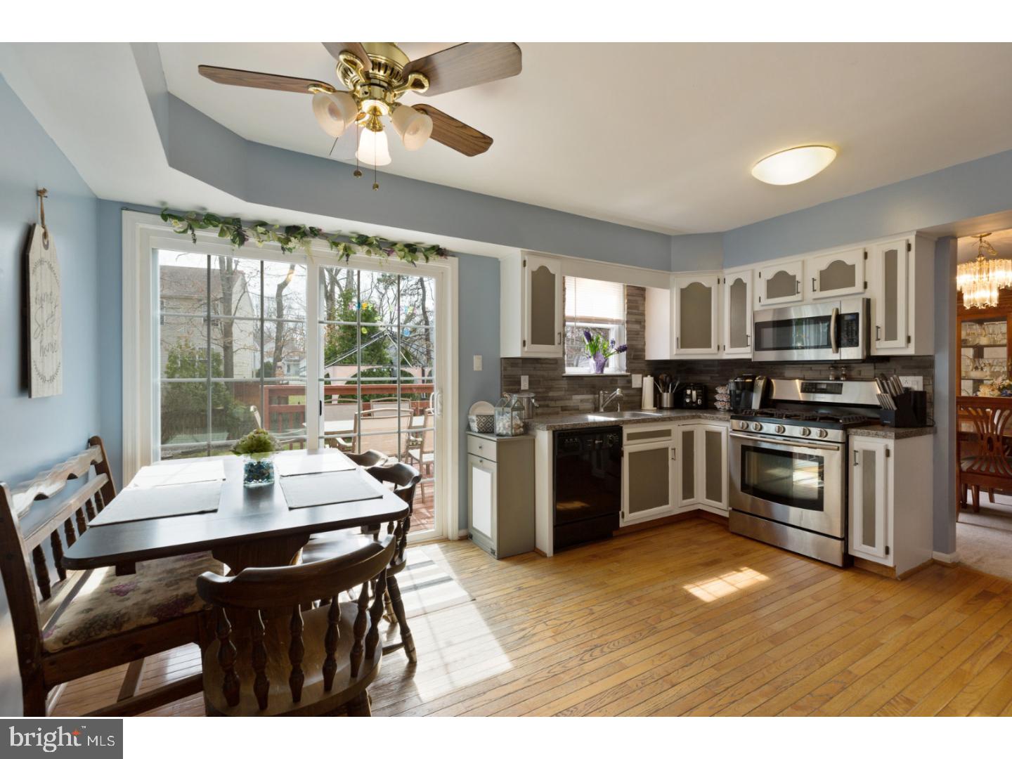 69 Country Club Road Pine Hill, NJ 08021 - Photo 8 of 25 a kitchen with a stove a sink a dining table and chairs