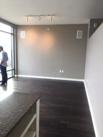 a view of room with window and wooden floor