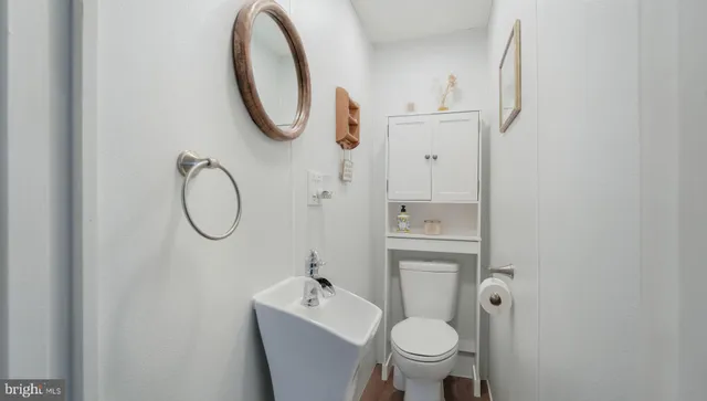 a bathroom with a toilet a sink and a mirror