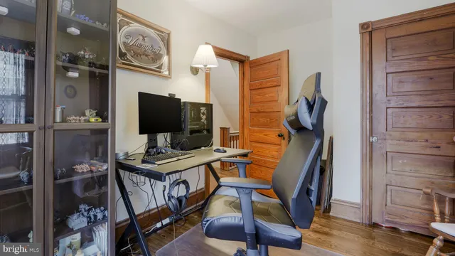 a view of a workspace with furniture and wooden floor