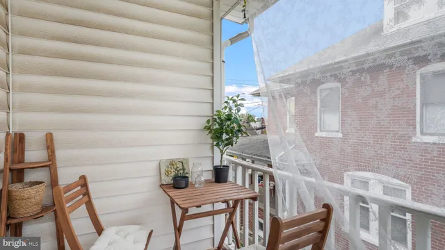 a view of a balcony with furniture