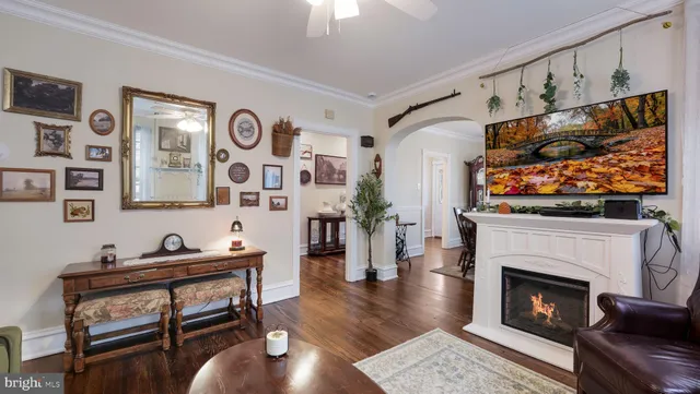 a living room with furniture and a fireplace