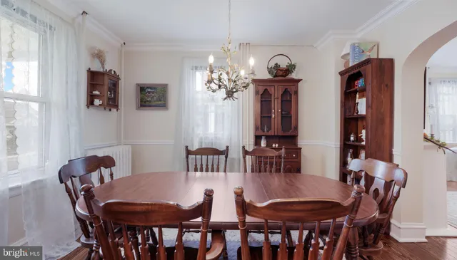 a view of a dining room with furniture and a chandelier