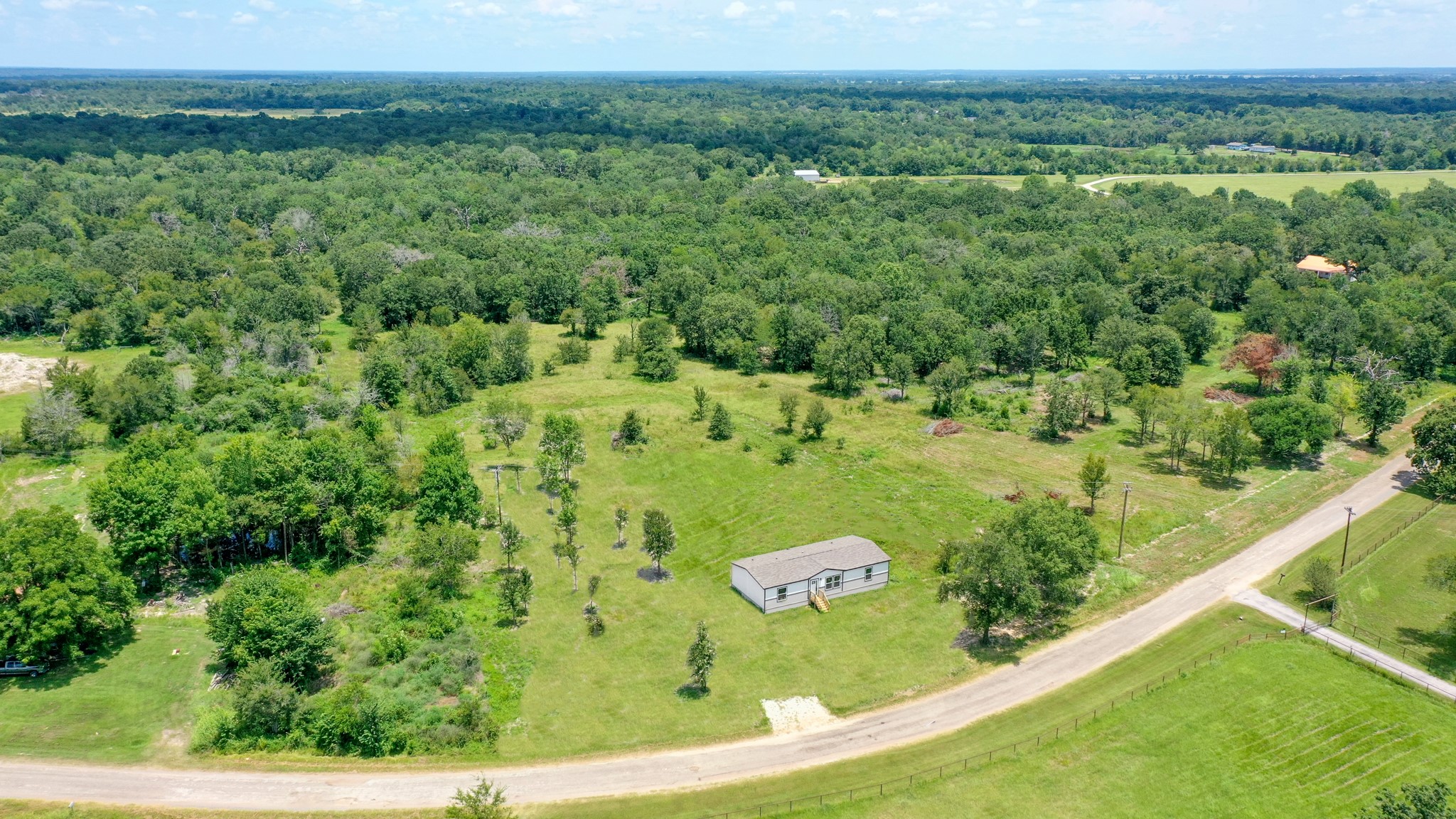 9960 Goose Prairie Road Midway, TX 75852 - Photo 2 of 28 Aerial Front View - AI Generated Grass