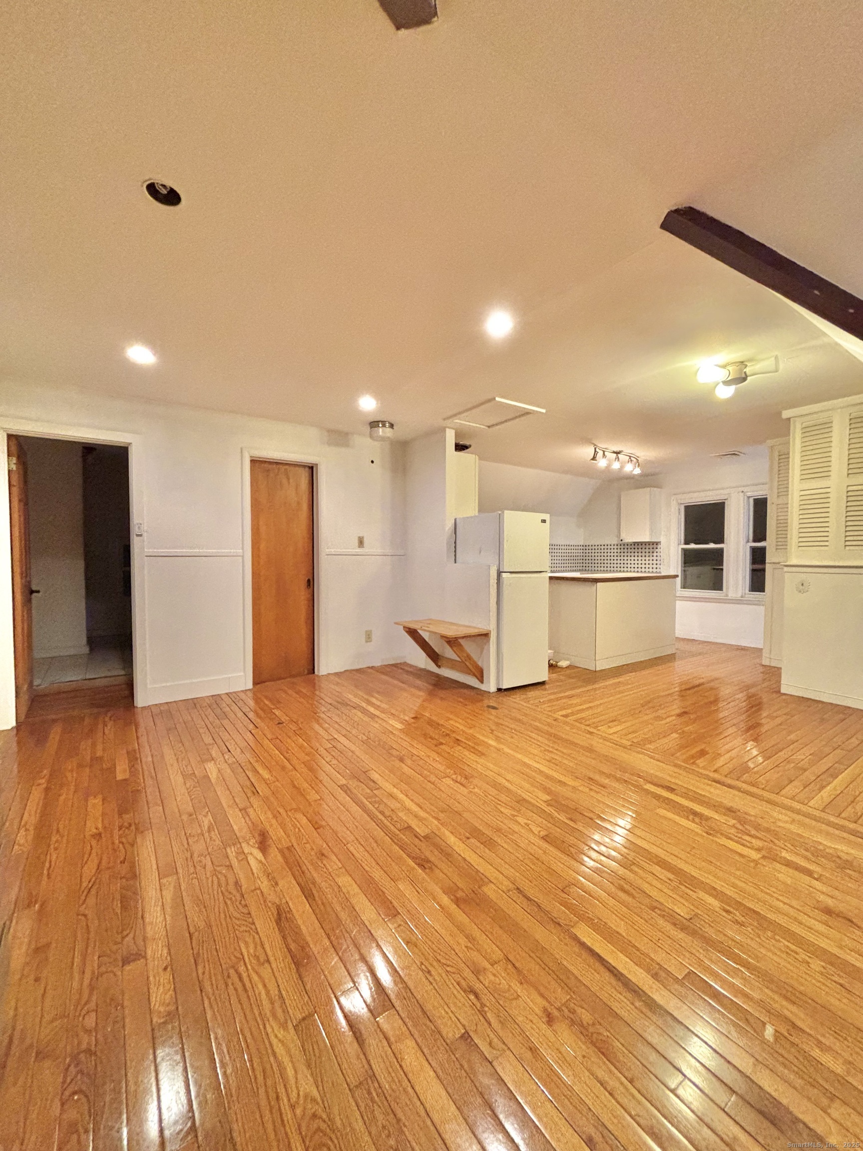 a view of a kitchen and a room