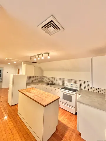 a bathroom with a sink a toilet a mirror and shower