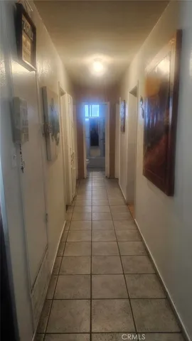 a view of hallway with a large window and chandelier