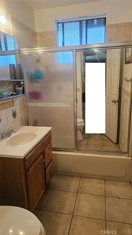 a bathroom with a sink a toilet and a shower