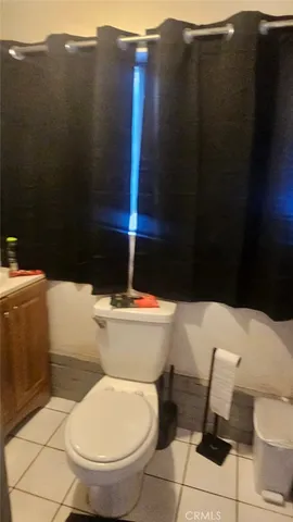 a white toilet sitting next to a shower curtain