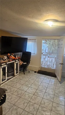 a view of a livingroom with workspace and a window