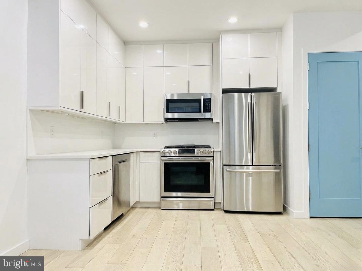 3527 14th Street Northwest, Unit 2 Washington, DC 20010 - Photo 1 of 19 a kitchen with a refrigerator and a stove top oven