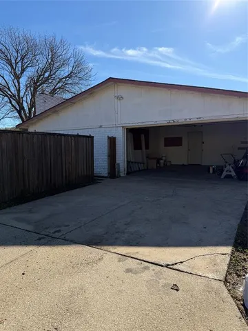 a view of a backyard with a large tree