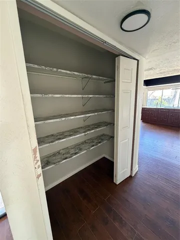 a view of a livingroom with wooden floor and a window