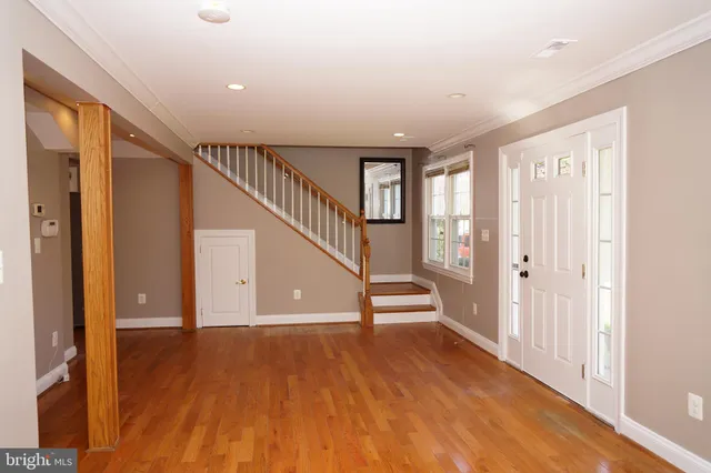 a view of entryway with wooden floor and stairs