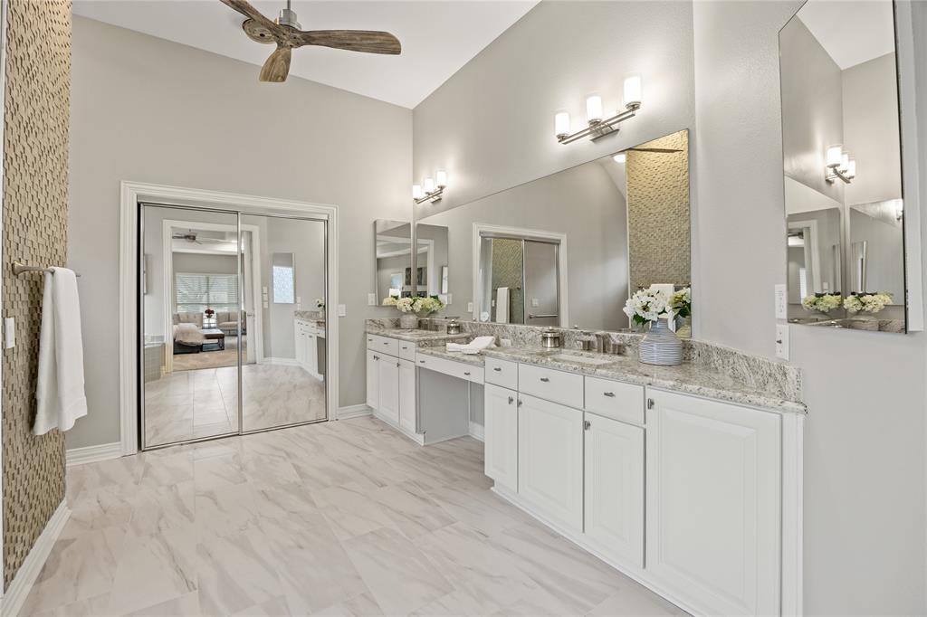 10409 Countryside Drive Denton, TX 76207 - Photo 26 of 38 Ensuite bathroom with ceiling fan, double vanity with granite countertops, vaulted ceiling, and light marble finish flooring