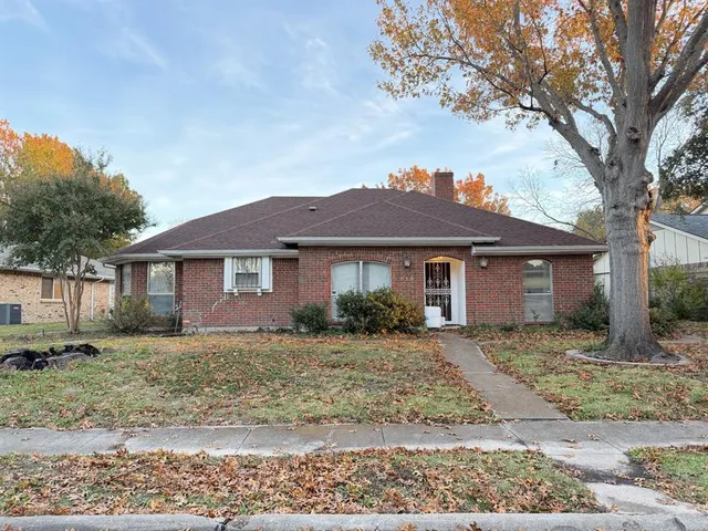 a view of a yard in front of a house with large tree