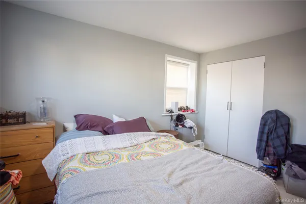 a bedroom with a bed and a chair