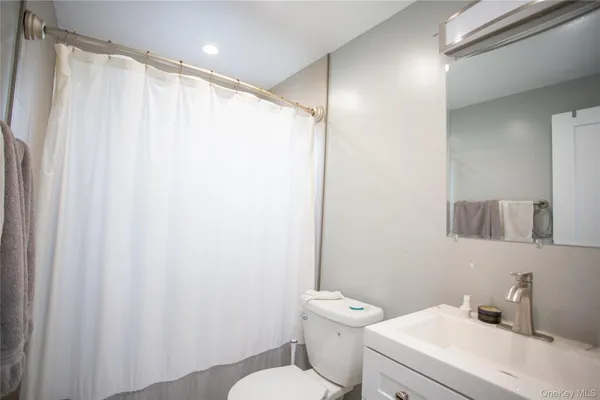 a white toilet sitting next to a bathroom sink