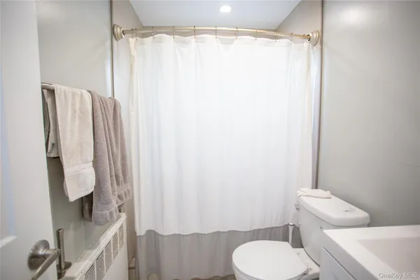 a white toilet sitting next to a bathroom sink
