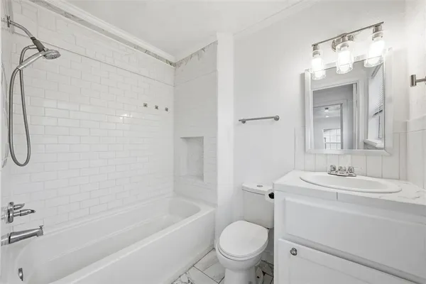 a bathroom with a sink toilet vanity and shower