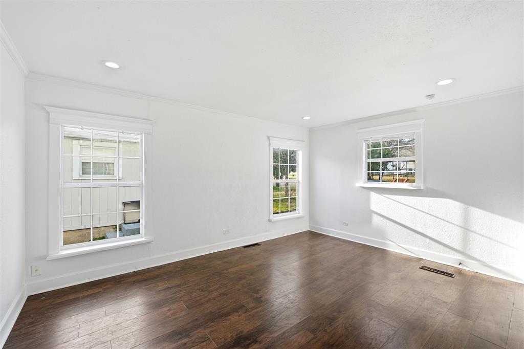 2712 Live Oak Avenue Waco, TX 76708 - Photo 3 of 15 a view of an empty room with a window and wooden floor