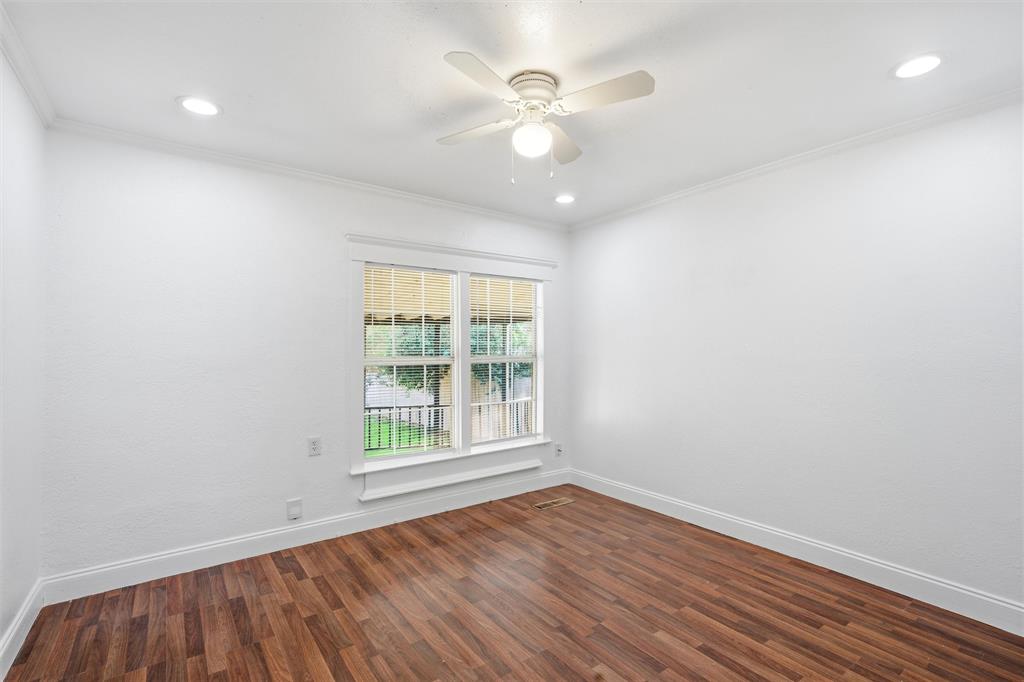 2712 Live Oak Avenue Waco, TX 76708 - Photo 7 of 15 an empty room with wooden floor and windows