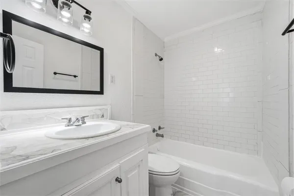 a bathroom with a bathtub shower sink and toilet