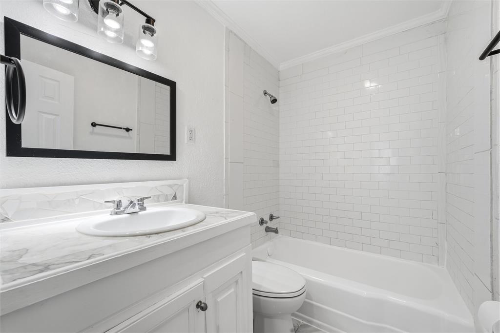 2712 Live Oak Avenue Waco, TX 76708 - Photo 9 of 15 a bathroom with a bathtub shower sink and toilet