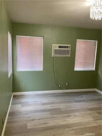 a kitchen with a wooden floor and a window