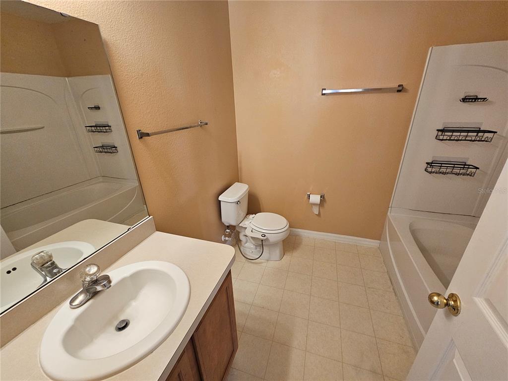 1881 Strathmore Circle Mount Dora, FL 32757 - Photo 14 of 16 a bathroom with a sink a toilet and shower