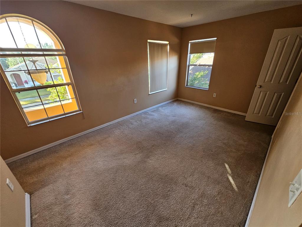 1881 Strathmore Circle Mount Dora, FL 32757 - Photo 15 of 16 an empty room with windows and closet