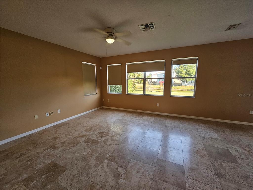 1881 Strathmore Circle Mount Dora, FL 32757 - Photo 3 of 16 a view of an empty room with a window