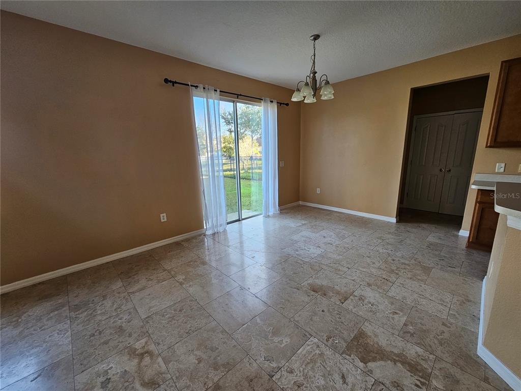 1881 Strathmore Circle Mount Dora, FL 32757 - Photo 4 of 16 a view of an empty room with a fireplace and a window