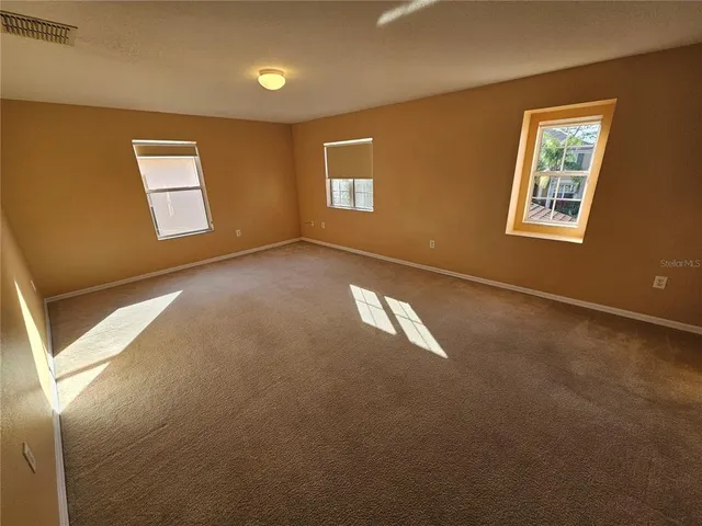 a view of an empty room with windows