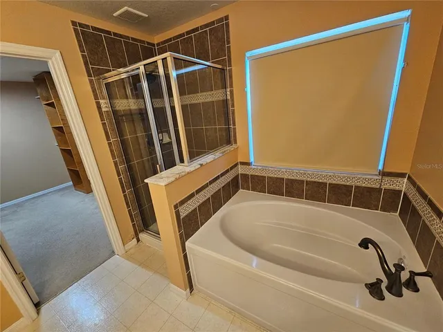a bathroom with a tub and shower
