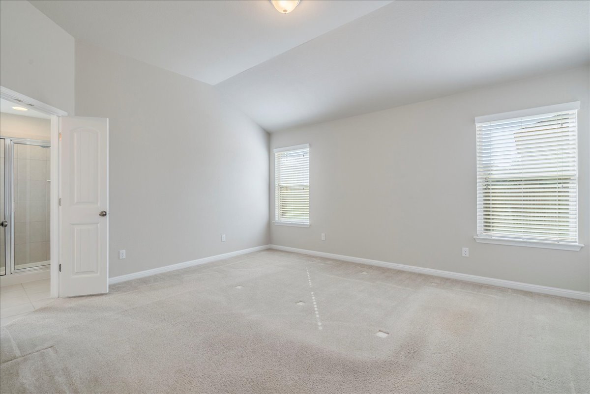 161 Mistflower Lane Kyle, TX 78640 - Photo 16 of 37 Unfurnished room featuring light carpet and lofted ceiling