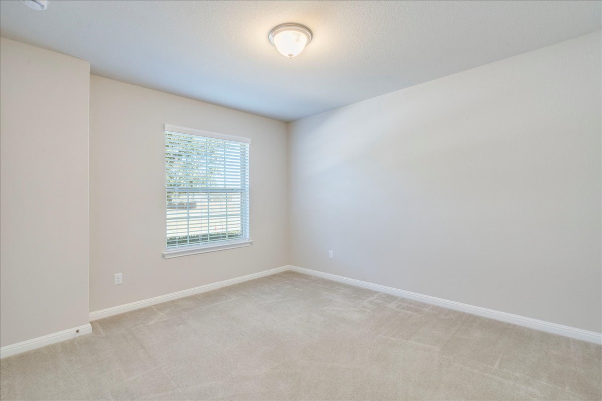 161 Mistflower Lane Kyle, TX 78640 - Photo 23 of 37 Empty room with baseboards and light colored carpet