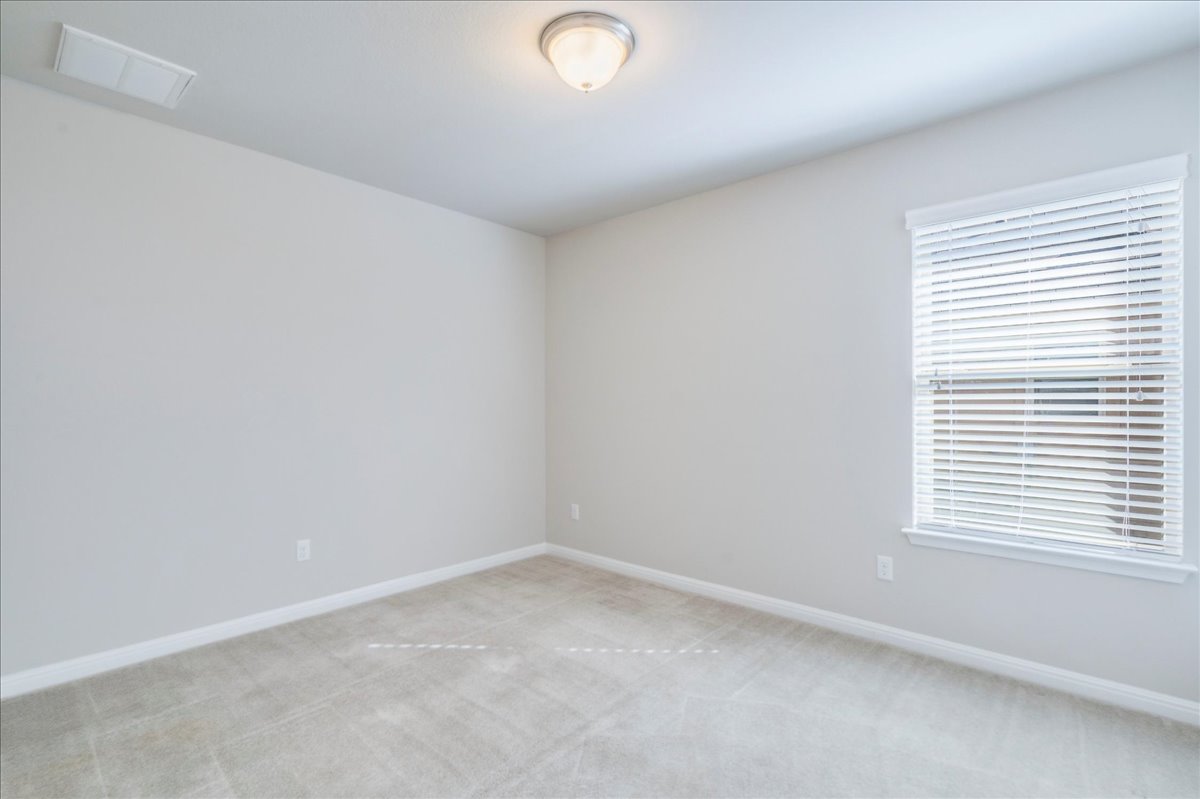 161 Mistflower Lane Kyle, TX 78640 - Photo 26 of 37 Unfurnished room featuring light colored carpet