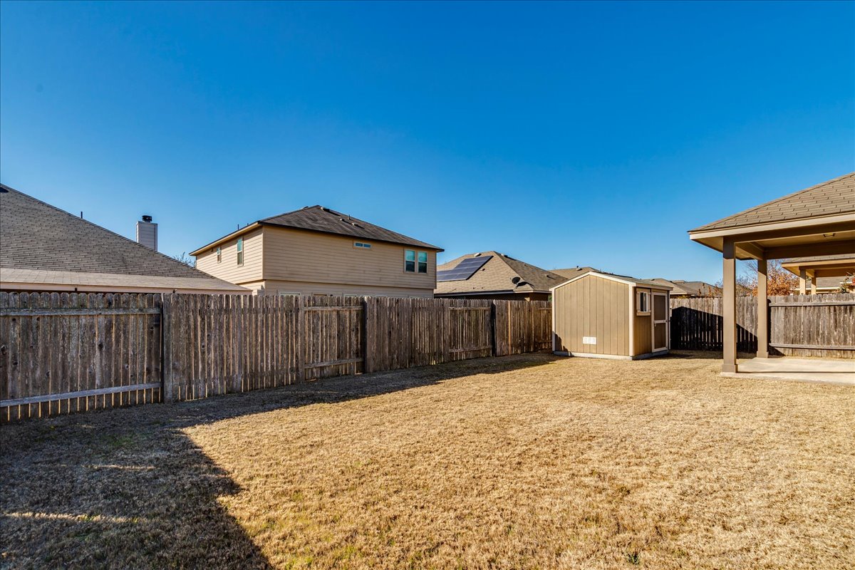 161 Mistflower Lane Kyle, TX 78640 - Photo 37 of 37 Fenced backyard with a shed and a patio