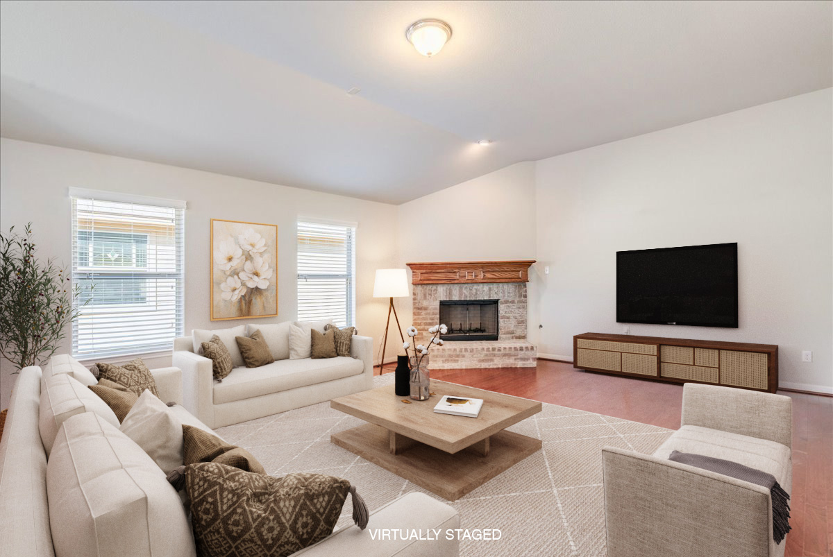 161 Mistflower Lane Kyle, TX 78640 - Photo 7 of 37 Living area featuring light wood finished floors, a brick fireplace, and vaulted ceiling