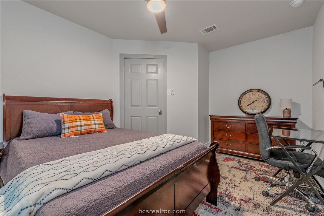 1027 Fallbrook Loop College Station, TX 77845 - Photo 12 of 20 a bedroom with a bed and a chandelier