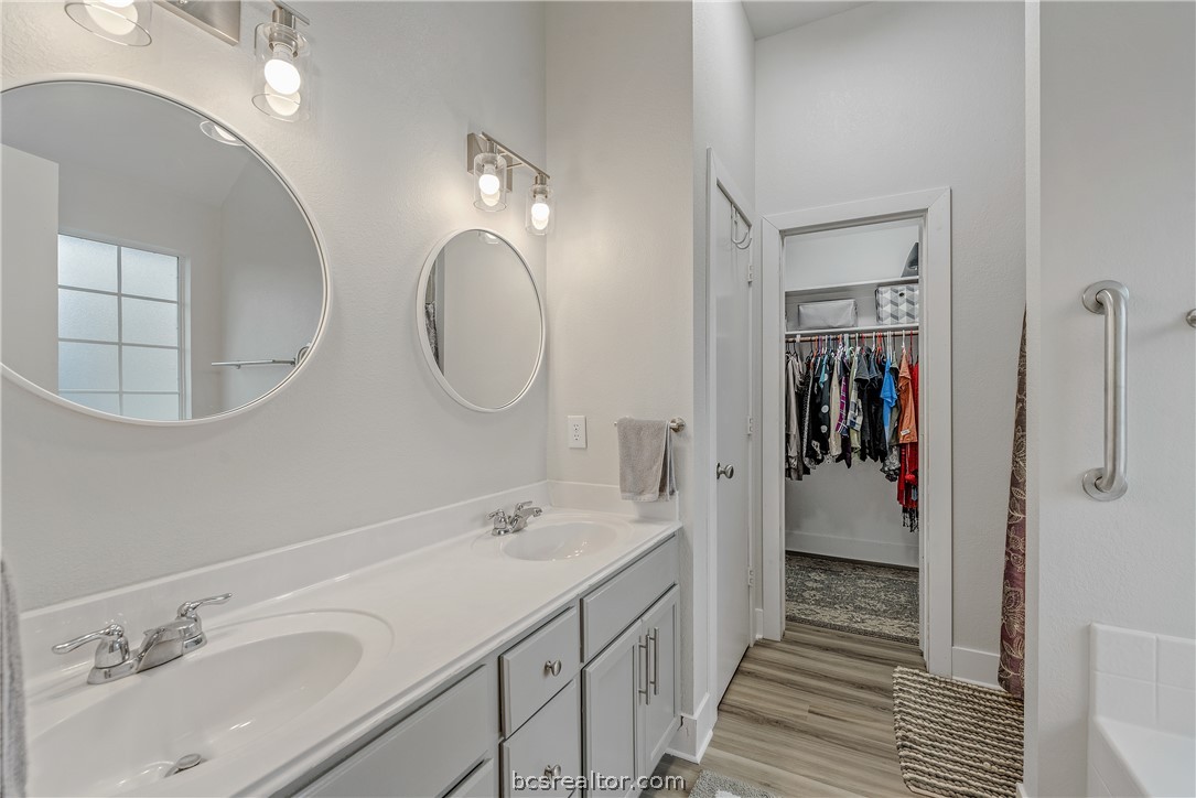 1027 Fallbrook Loop College Station, TX 77845 - Photo 16 of 20 a en suite bathroom with a double vanity sink and a mirror