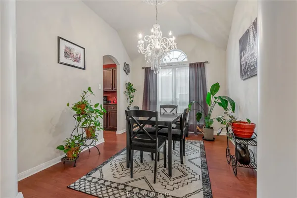 a view of a dining room with furniture and chandelier